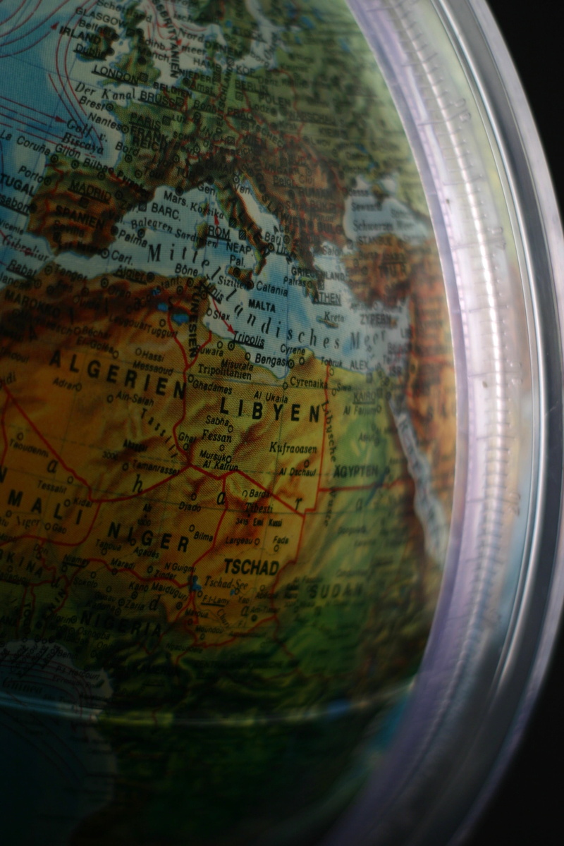 communication, indoors, no people, close-up, direction, western script, map, planet earth, 2K, selective focus, text, glass - material, travel, world map