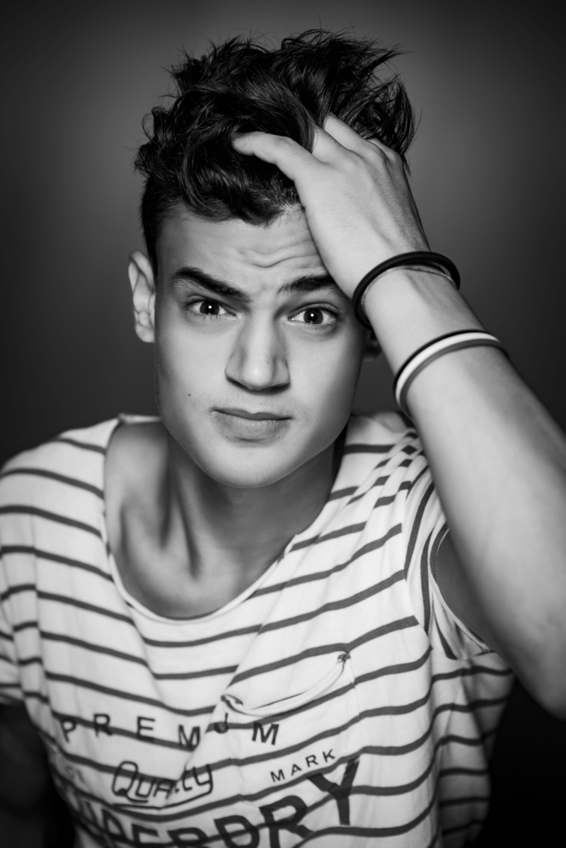 lifestyles, portrait, hairstyle, shirt, focus on foreground, vignette, dark, eyes, wear, black and white, studio, striped, black background, one person