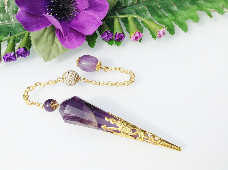 jewelry, beauty in nature, spirituality, close-up, purple, tool, 2K, mystical, precious gem, cut out, new age, ornate, indoors, gold colored, studio shot