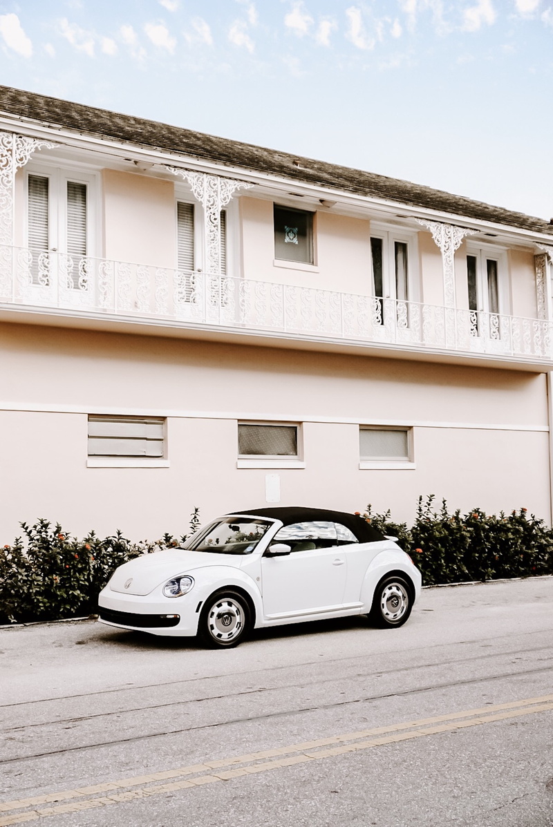 mode of transportation, outdoors, car wheel, building exterior, wheel, wall, residential district, alloy wheel, person, home decor, car, daytime, luxury