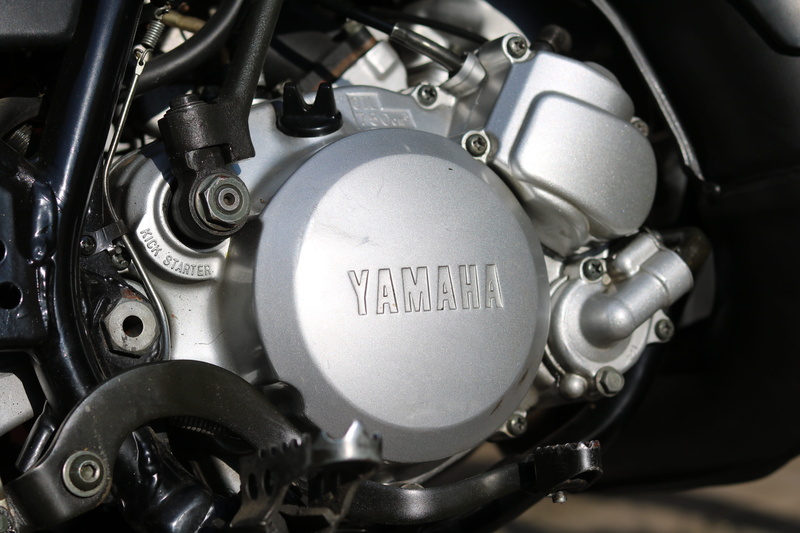 motor vehicle, drive, text, machine, no people, motor, control, yamaha, vehicle part, shiny, silver colored, transportation, machinery, black, steel, engine block