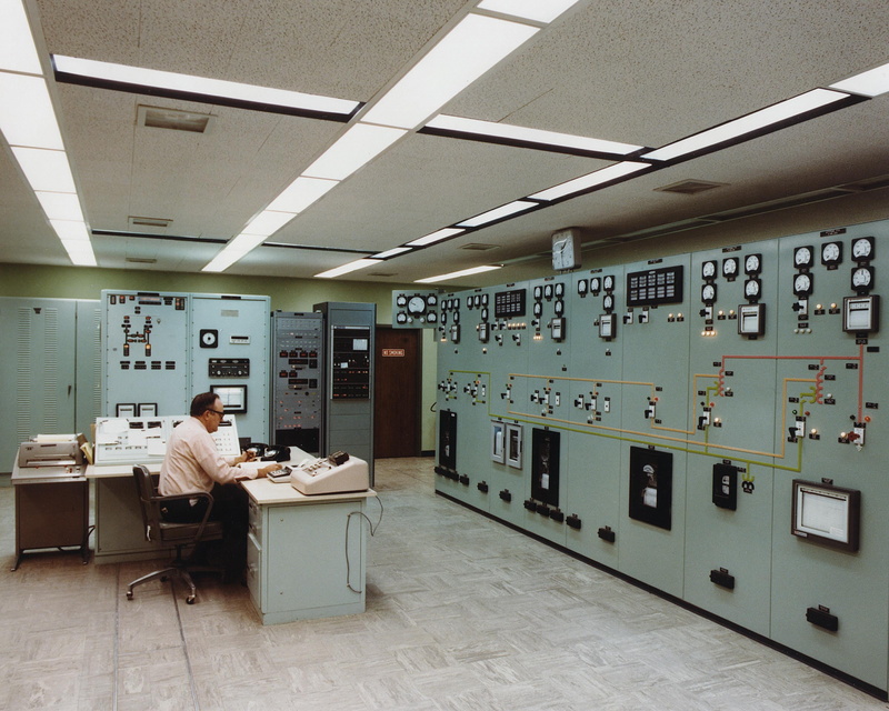 education, one person, ceiling, men, white collar, white, control room, real people, seat, full length, cabinets, power, table, technical, control panel