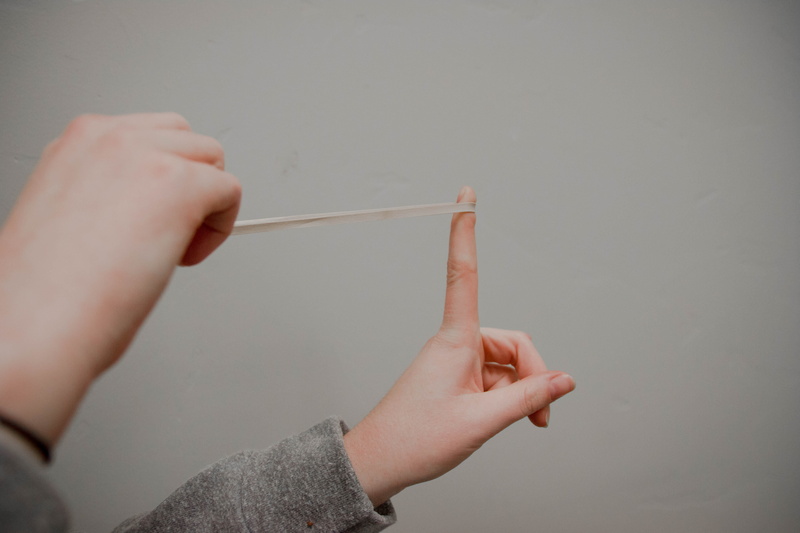 human arm, elastic band, holding, limb, adult, rubberband, gesturing, human limb, one person, close-up, band, finger, gray, women, human body part, hand