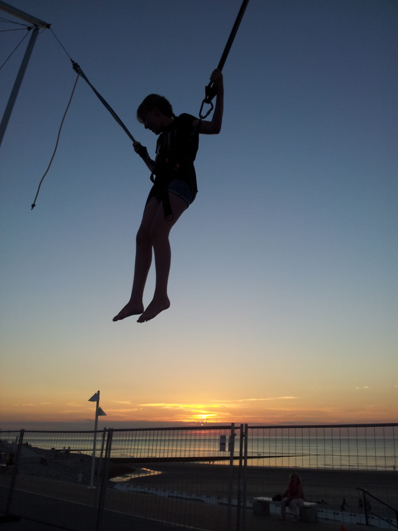 action, sky, boys, Trampoline, men, elastic, silhouette, real people, 2K, males, person, orange color, Woman, jumping on a trampoline, hanging, harness
