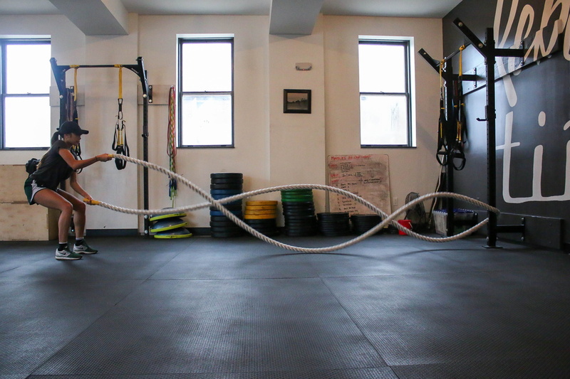 using, self improvement, battle, sports clothing, woman, holding, effort, gym, lifestyles, adult, performing, full length, ropes, sport, women, day, leisure activity