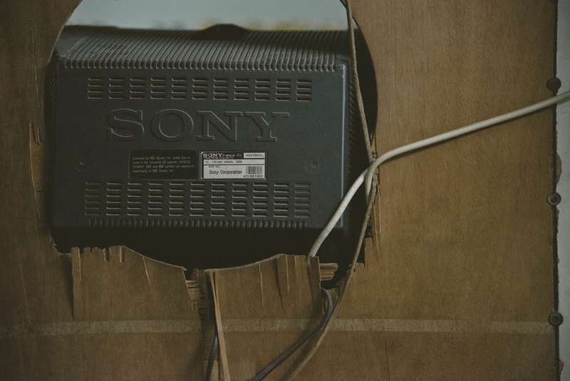 western script, mouse, no people, day, server, appliance, sony, music, close-up, screen, wall - building feature, table, equipment, adapter, audio speaker