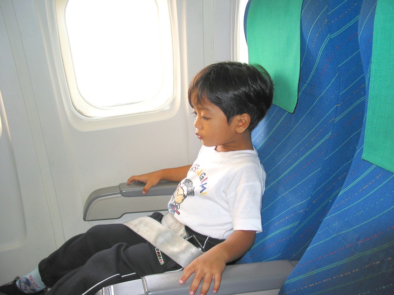 boys, travel, innocence, seat, plane, casual clothing, flight, real people, vehicle interior, joy, one person, transportation, airplane seat, child, vehicle seat