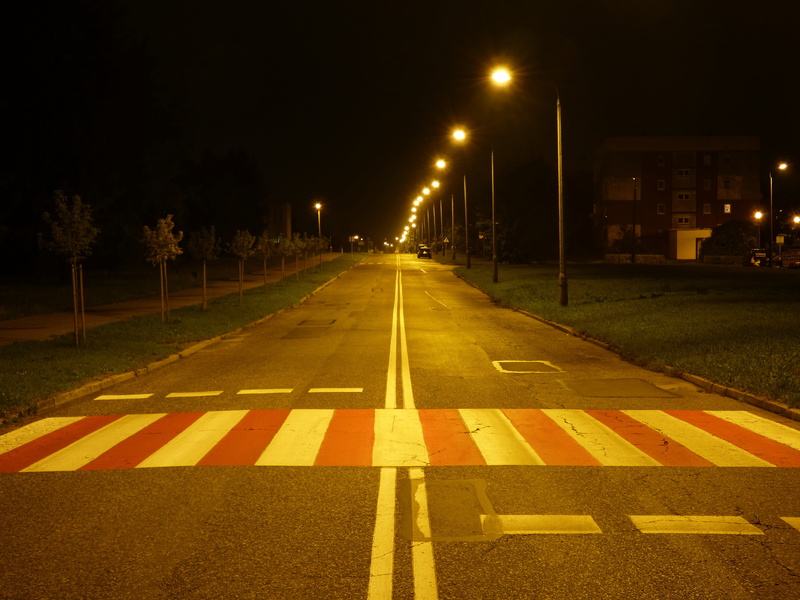 surface level, night, the way forward, city, light, no people, diminishing perspective, dividing line, lantern, sign, road, seat belts, transportation