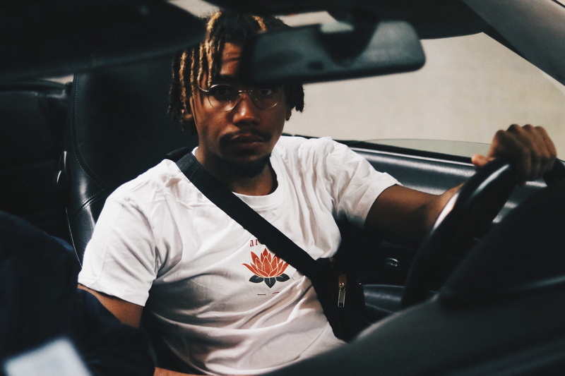 driver, mode of transportation, leisure activity, lifestyles, front view, young men, indoors, motor vehicle, one person, black, glasses, young adult, car