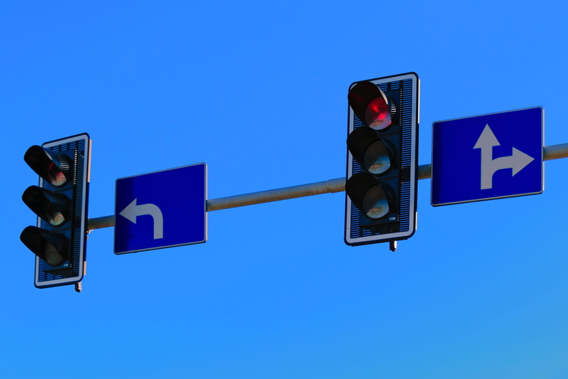 the intersection, symbol, blue, road, cars, low angle view, pedestrian crossing, traffic arrow sign, traffic control, high beam, blue background, stoplight