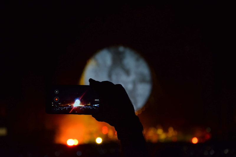 occupation, photography themes, music, colors, technology, concert, song, outdoors, camera - photographic equipment, hand, photo, looking through an object