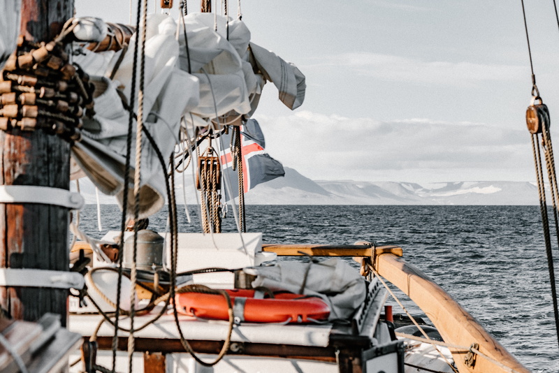 day, military uniform, outdoors, sailing, pulley, yacht, window, sailor suit, sailing ship, rigging, navy, water, sea, travel, vest, ocean, officer, boat
