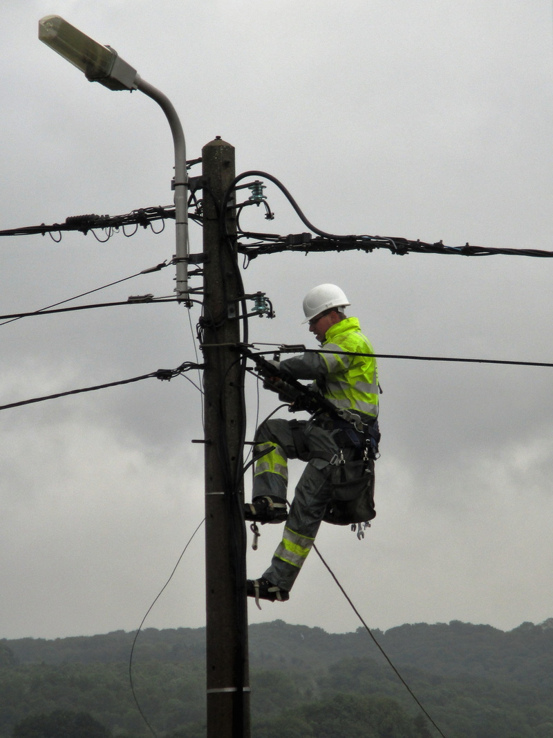 power pole, electrician, occupation, men, outdoors, worker, cable, electric wires, helmet, electricity pylon, one person, technology, working, sky, protection