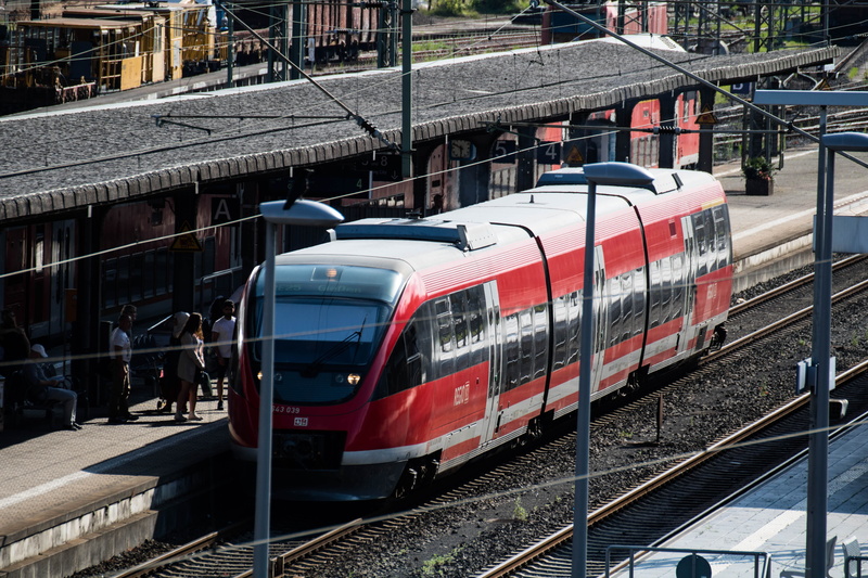 motion, mode of transportation, incidental people, passenger train, track, railroad station platform, rail transportation, railroad car, public means of transport