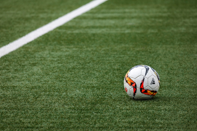 sphere, football - Ball, line, outdoors, green color, grass, ball, team sport, football field, soccer field, success, no people, sports ground, football pitch