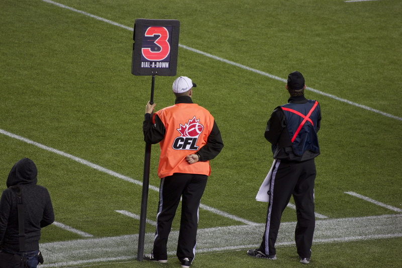 men, sport, people, number, clothing, day, adult, rear view, standing, outdoors, athlete, mid adult, canadian, sign, athletics, full length, uniform, grass
