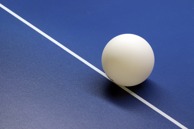 blue, activities, break, colored background, white room, table, sport, no people, sphere, indoors, white color, racket, hobby, motion, sports equipment