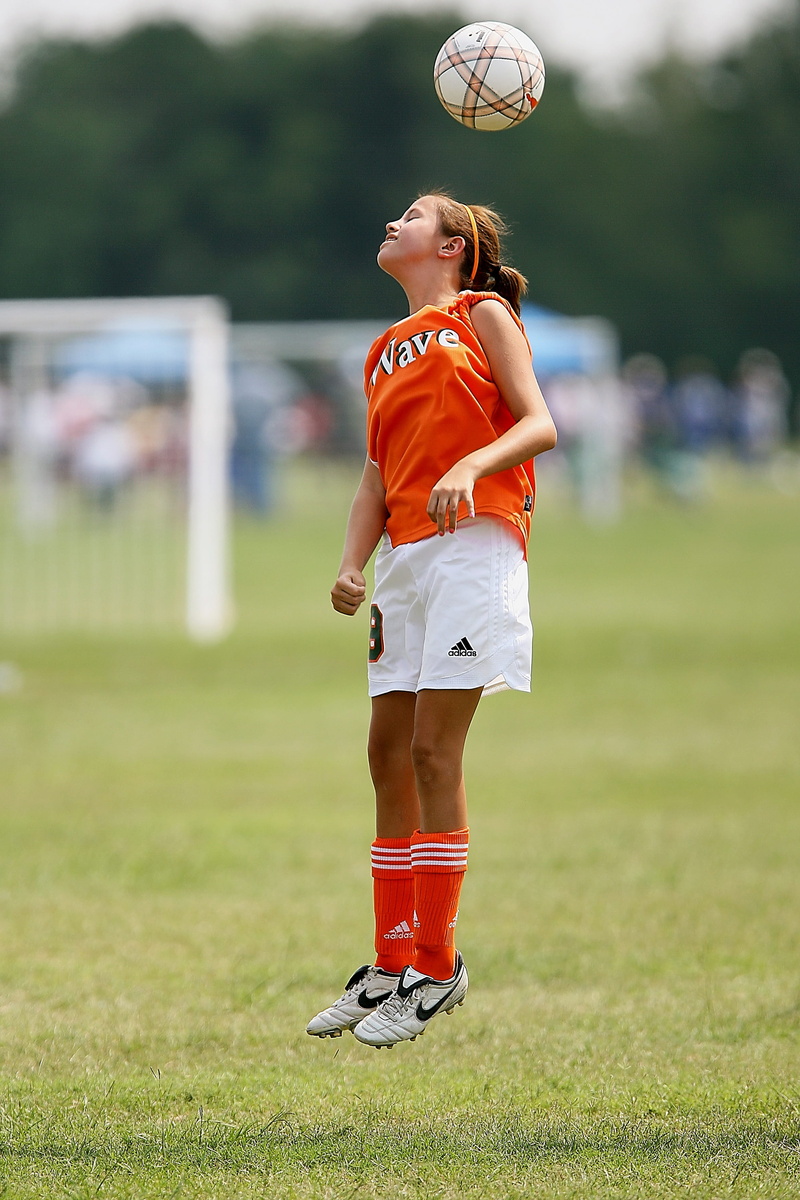 women, team sport, skill, ball, active, field, one person, grass, sports equipment, soccer team, girl, full length, clothing, activity, athletic, football