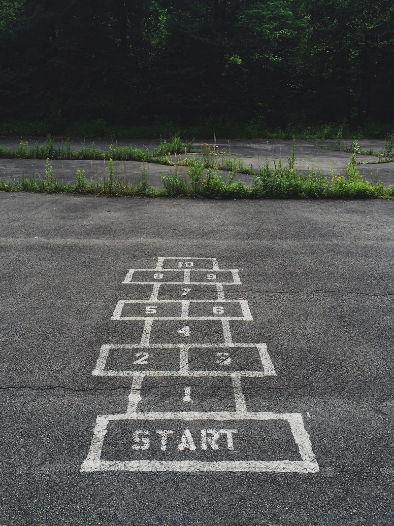 road, day, leisure games, park, plant, playground, concrete, tree, relaxation, gray, start, game, numbering, high angle view, number, grass, tarmac, drawing - art product