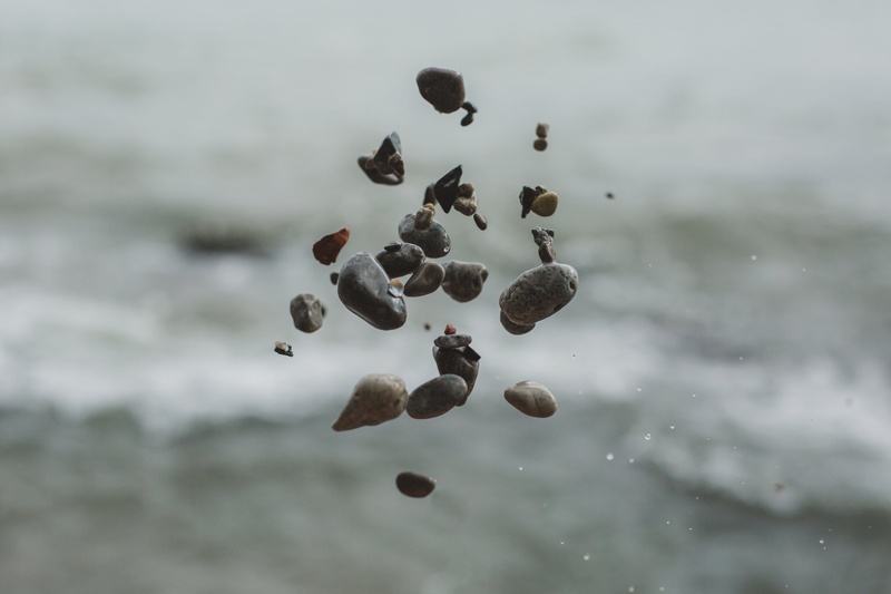 mid-air, flying, rock, brown, travel, sky, coast, air, stone, food and drink, large group of objects, motion, still life, summer, mineral, beauty in nature