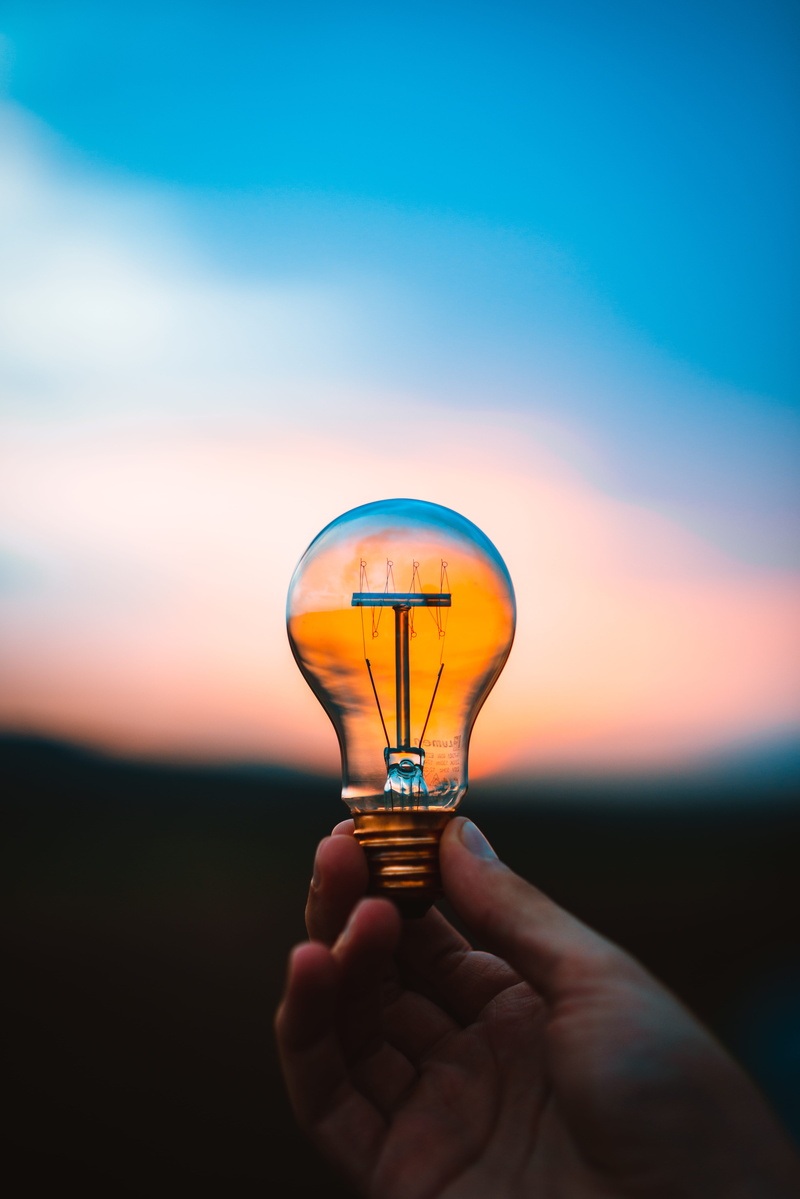 illuminated, light Bulb, hold, lighting Equipment, sky, glowing, power Supply, imagination, concepts, person, warm, bokeh, electricity, motivation, invention