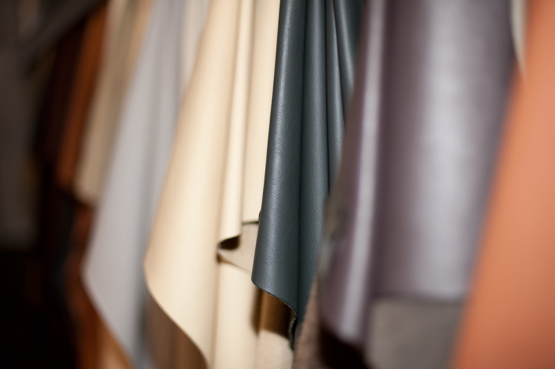 indoors, large group of objects, pattern, selection, upholstery, retail, hanging, rack, lot, photo, retail display, fashion, order, leather fan, variation