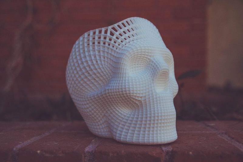 close-up, skull, artwork, brick wall, indoors, sculpture, representation, single object, textile, floor, statue, human, art and craft, human representation
