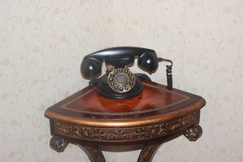 table, indoors, history, no people, antique, props, interior, rotary phone, wall - building feature, nostalgia, technology, connection, the past, telephone receiver
