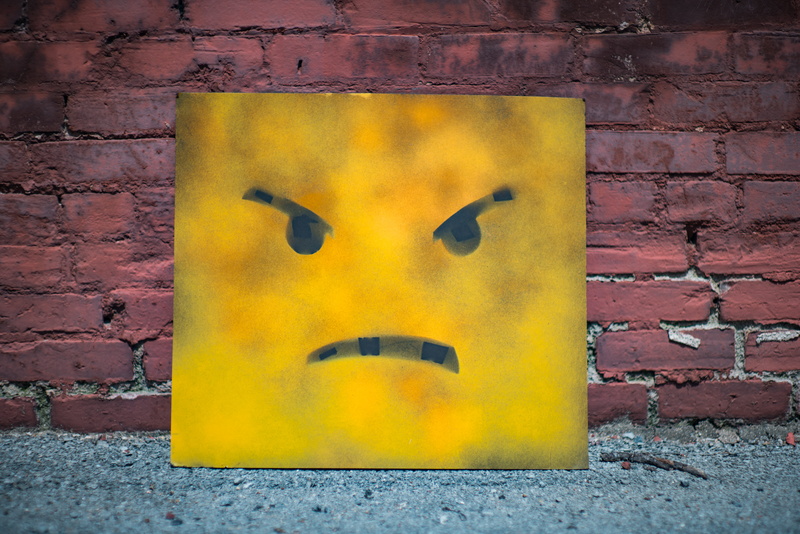 brick, outdoors, wall - building feature, brick wall, representation, wall, 8K, close-up, mural, architecture, yellow, mad face, multi colored, day, built structure