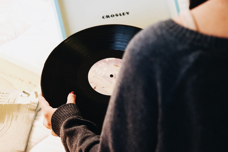 vinyl, leisure activity, holding, human body part, technology, black, arts culture and entertainment, person, high angle view, hand, musical instrument