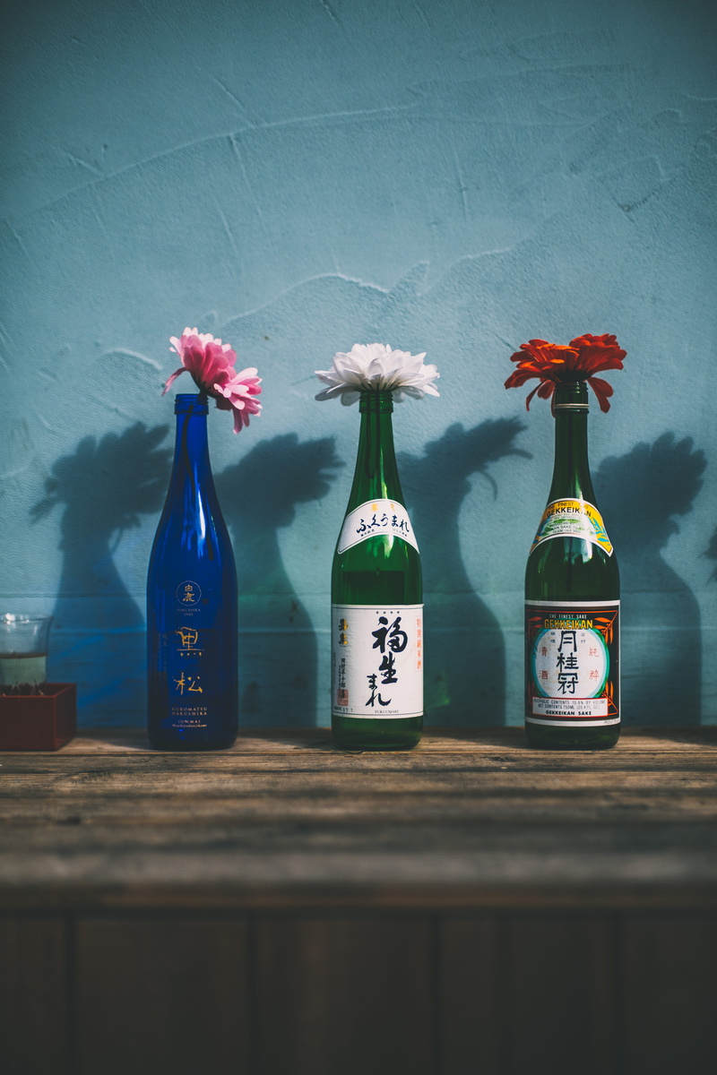 plant, bottle, peony, flower, container, indoors, blue, flowering plant, communication, three, hanging, interior design, beverage, no people, wall, table
