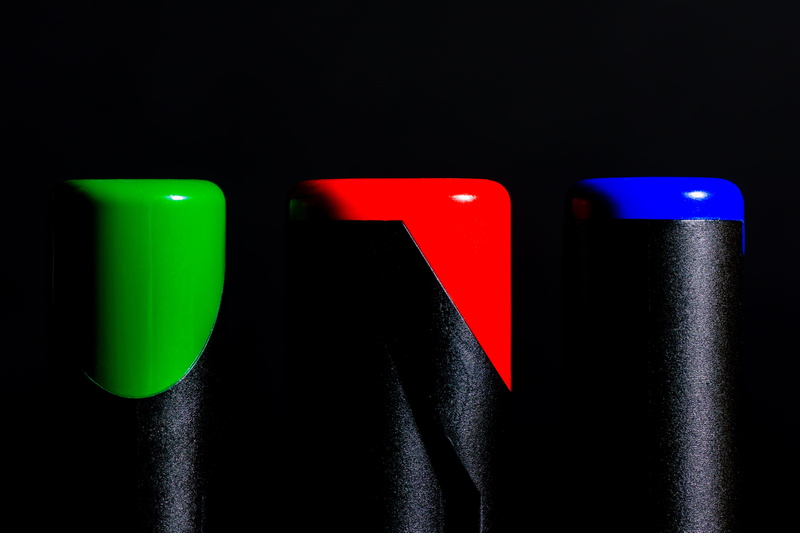 pens, design, paint, indoors, black background, arts culture and entertainment, school, green color, draw, backgrounds, close-up, bottles, global communications