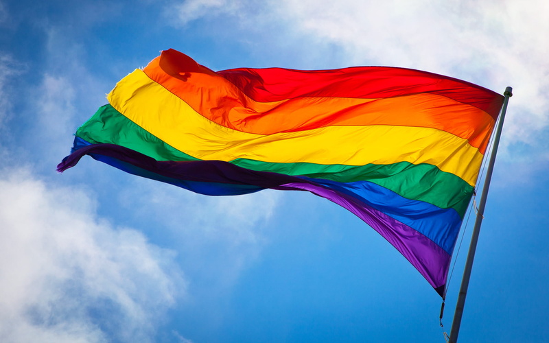 waving, wind, symbol, vibrant color, emotion, low angle view, red, outdoors, environment, flag, multi colored, yellow, nature, gay pride flag rainbows colorful sky clouds san francisco windy culture lgbt