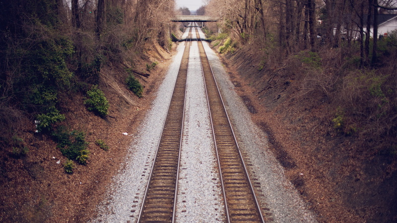 rail transportation, land, outdoors, day, track, diminishing perspective, 2K, no people, architecture, vanishing point, transportation, plant, parallel