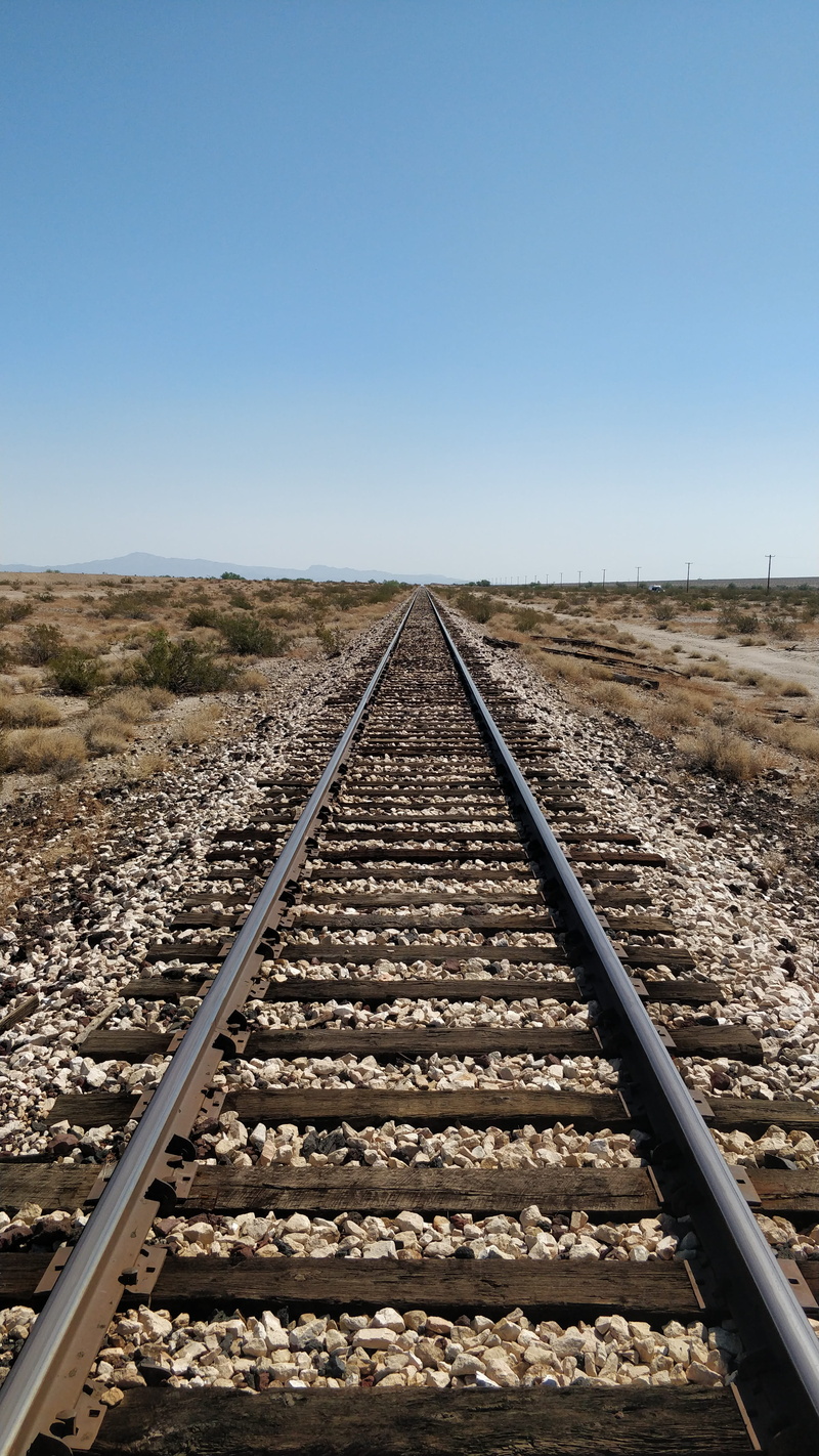 wanderlust, diminishing perspective, transportation, vanishing point, traintrack, straight, horizon, non-urban scene, sunlight, rail, copy space, joshua tree national park