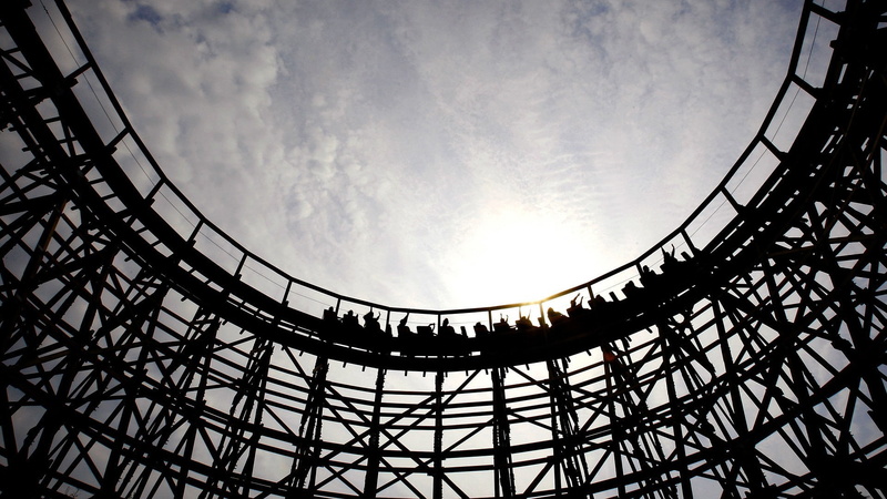 wood, city, circle, low angle view, amusement park, sunlight, curve, amusement park ride, outdoors, built structure, arts culture and entertainment, cloud - sky