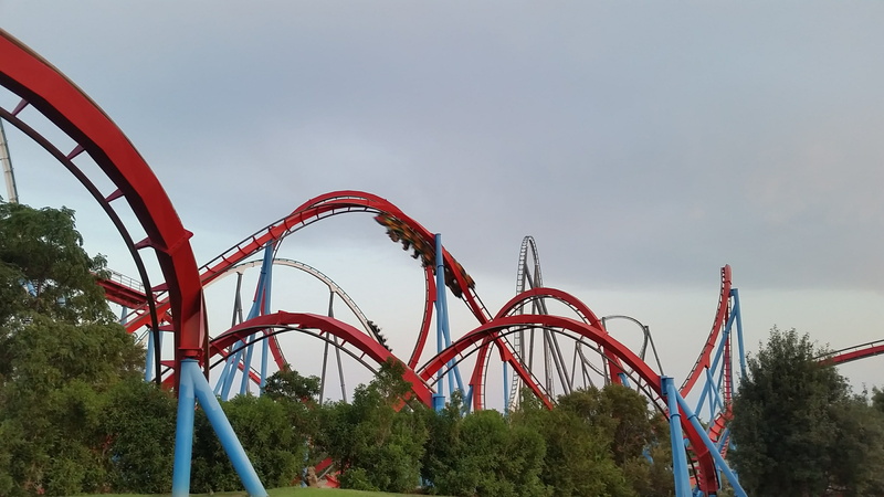 enjoyment, amusement park, outdoors, blue, low angle view, built structure, metal, fun, sky, red, nature, park, vila-seca, adventure, tree, roller coaster