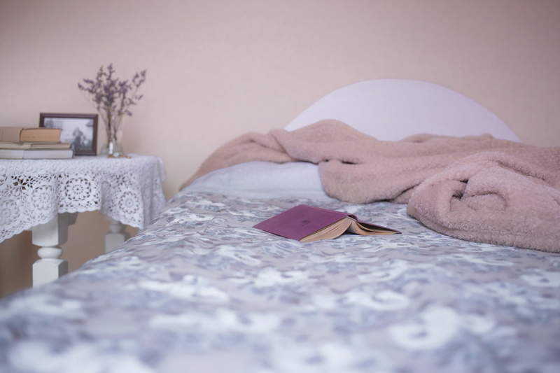 room, printed comforter, beauty, tranquility, hotel, bed, book, white, indoors, floral, luxury, sleep, day, cozy, lying down, lace table cover, no people