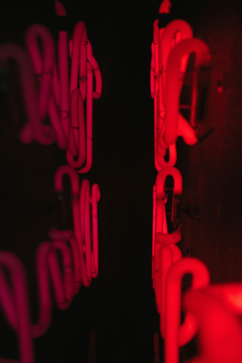 signage, body part, indoors, 5K, color, aggression, sign, letter, black, close-up, safety, color degrade, photo, selective focus, black background