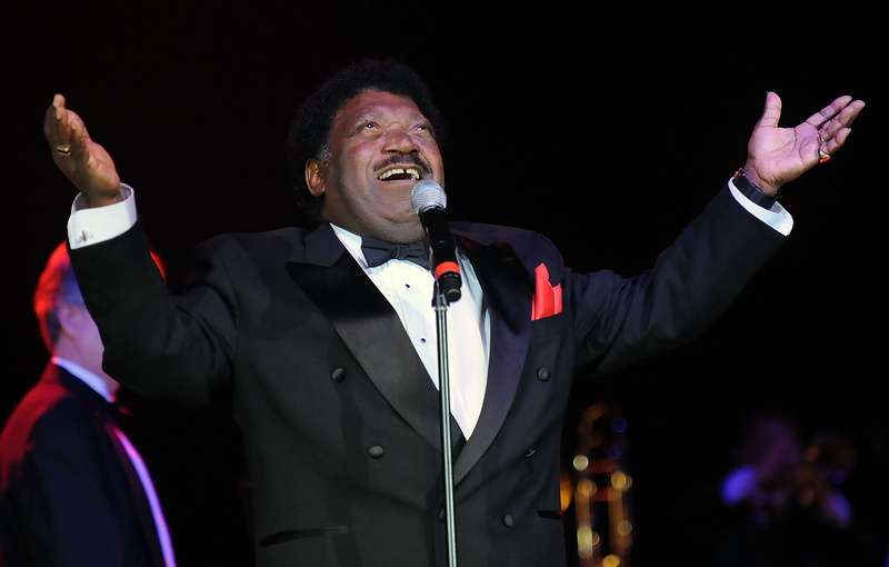 singer, mouth open, human arm, r and b, cheerful, arts culture and entertainment, lapel, s, jacket, happiness, human limb, body part, one person, waving