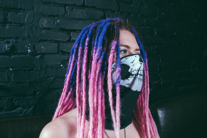 purple, dread, dyed hair, front view, one person, human face, scarf, standing, young adult, mask, portrait, wall - building feature, obscured face, looking at camera