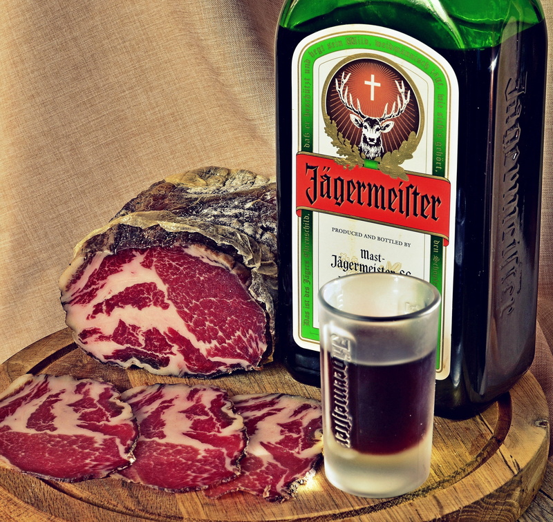 delicacy, meat, processed meat, beef, jägermeister, glass, food, text, bottle, indoors, pork, 2K, restaurant, table, drinking, no people, close-up, cappicola