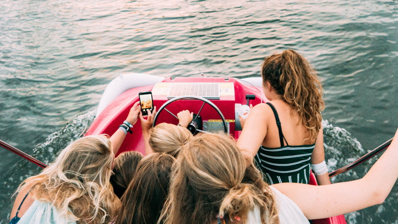 togetherness, riding, mode of transportation, transportation, leisure, sitting, teenager, boat, watercraft, beach, hairstyle, people, pedalo, love, sea