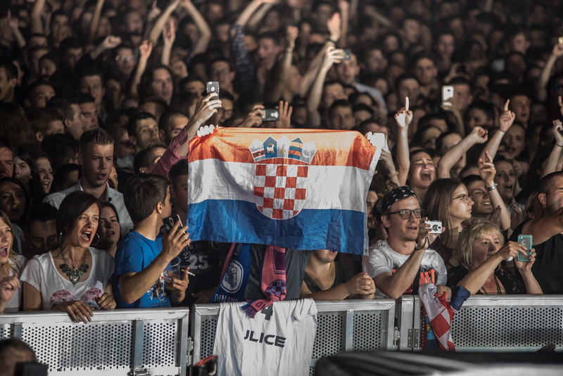 watching, fan - enthusiast, excitement, emotion, young adult, mobile phone, real people, yell, cheering, flag, seat, taking, photo, spectator, enjoyment