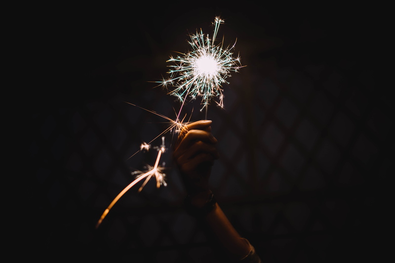 glitter, firework - man made object, one person, sparks, sprinklers, light, human hand, event, illuminated, firework, sparkler, glowing, long exposure