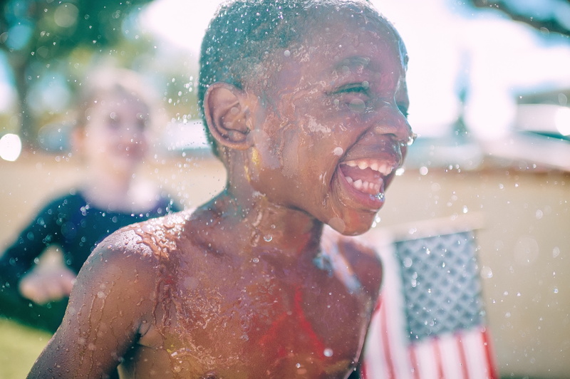 front view, child, boy, kids, males, laughing, playing, smiling, children, usa, wet, emotion, cheerful, daytime, adult, outdoors, architecture, fun, happiness