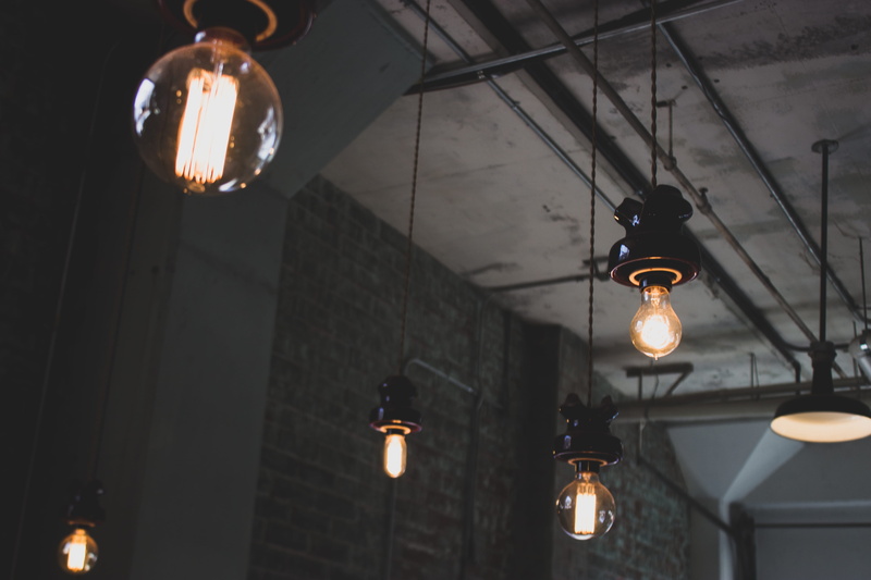 light fixture, lights, focus on foreground, architecture, due south coffee roasters, indoors, lantern, low angle view, electric lamp, ceiling, glowing
