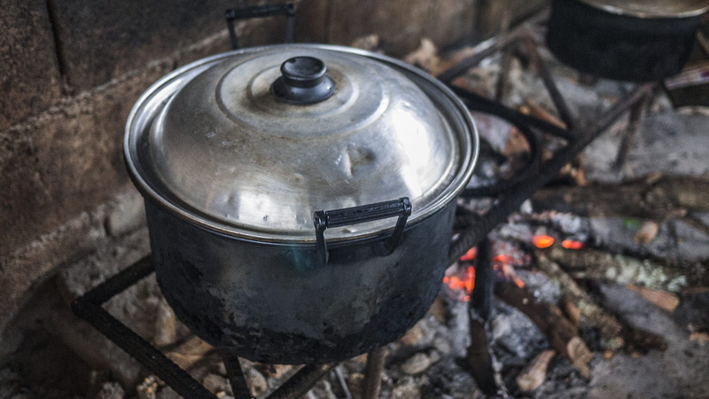 wood burning stove, burning, bbq, focus on foreground, 2K, stew, beverage, no people, food, cooking, clothing, fire, cooking pan, close, silver colored