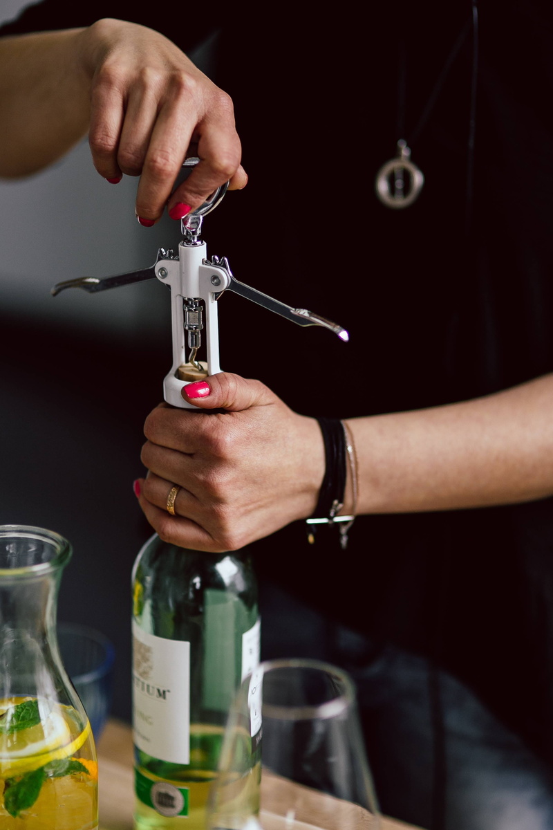 holding, woman, indoors, adult, food and drink, 4K, corkscrew, cork, midsection, alcohol, bottle, human body part, focus on foreground, opening, Hands