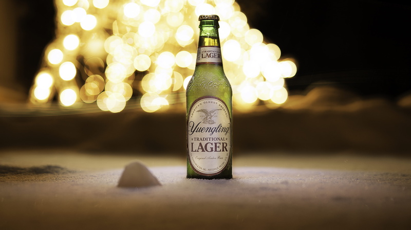 food and drink, no people, close-up, container, beach, white, single object, text, illuminated, bokeh, yuengling, wine bottle, sand, western script, refreshment